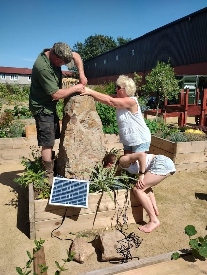 installing water feature in the newbold community growing together community garden