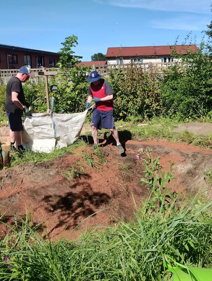 installing water feature in the newbold community growing together community garden